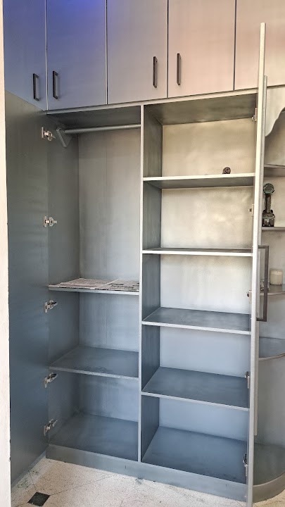 Internal storage layout of floor-to-ceiling custom bedroom wardrobe with solid timber shelving