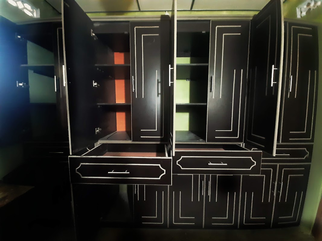 Open wardrobe view demonstrating internal shelving tiers and hanging rod