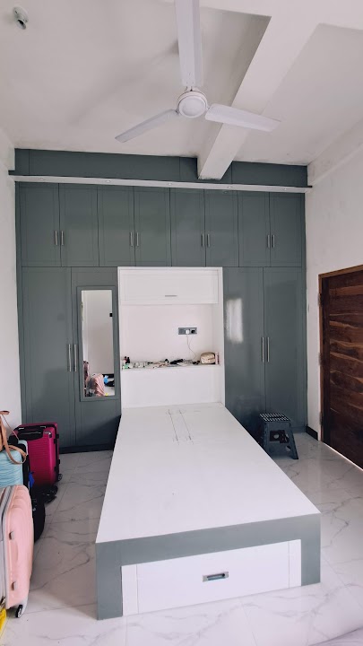 Full front view of custom floor-to-ceiling bedroom wardrobe suite with integrated bed frame and storage drawer