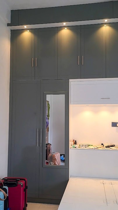 Close-up of mirror closet door and illuminated bedhead alcove