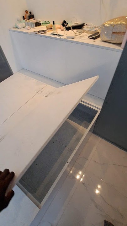 Demonstration of hinged lift-up internal storage compartment inside the bed