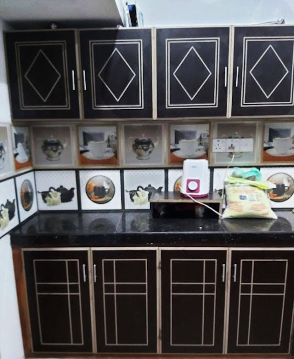 Dark kitchen cabinets with light geometric outlines on the doors