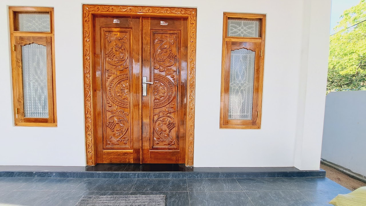 Wide veranda view of installed carved medallion entrance doors