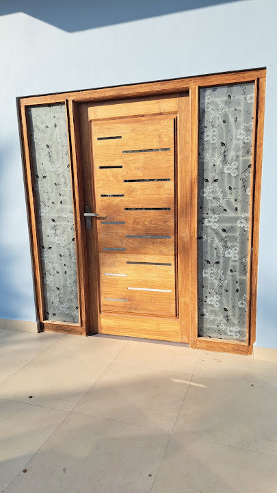 Contemporary timber entrance with vertical detailing and side glazing