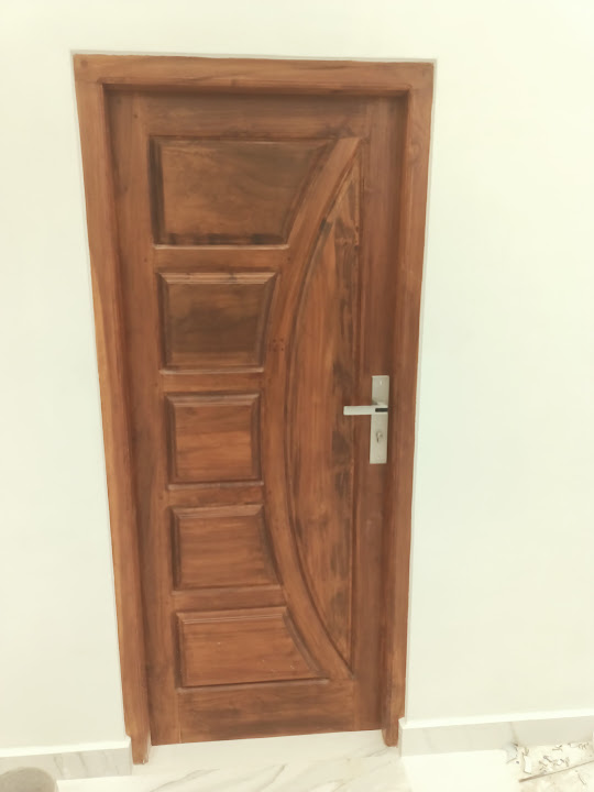Single timber door with rectangular panels and a broad curved inset