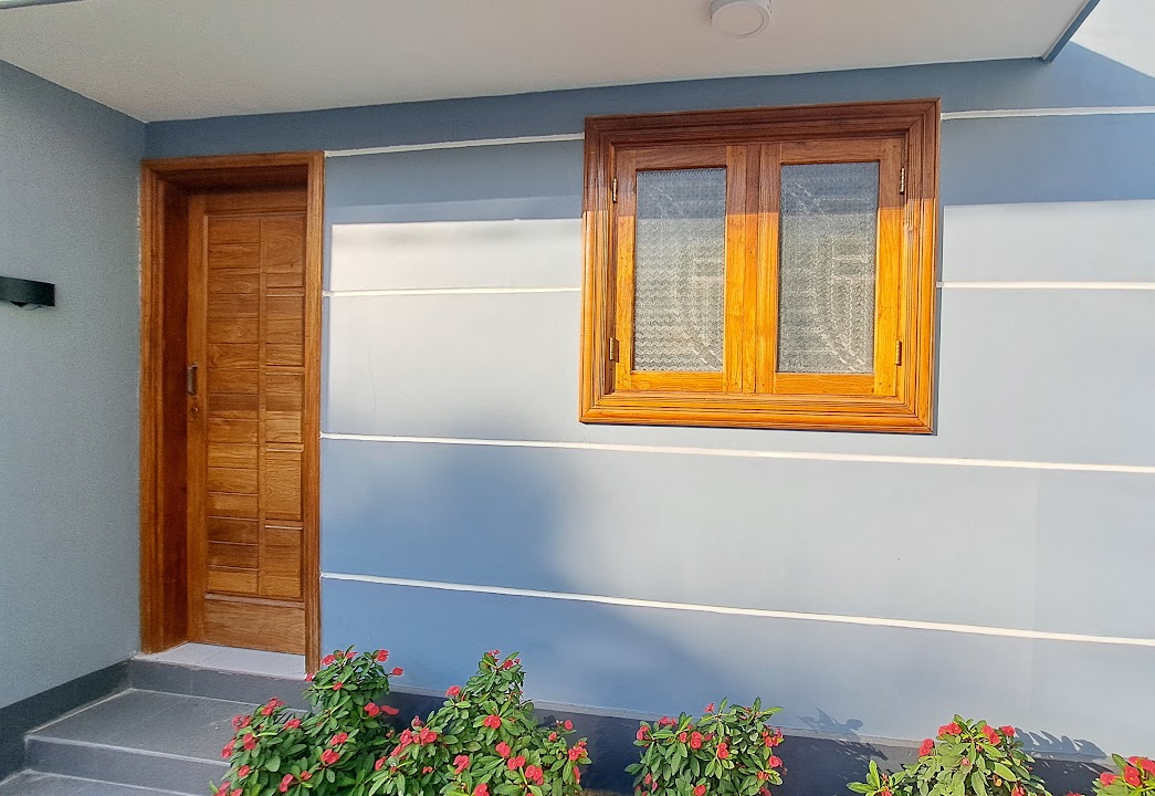 Exterior wall facade showing door with adjacent casement window