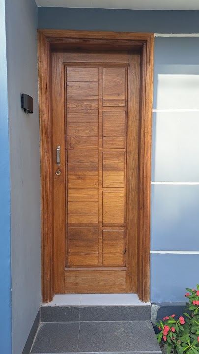 Full front view of single contemporary grooved timber entrance door with porch steps and planter