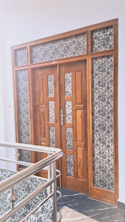 Angled perspective view showing entrance with balcony railing