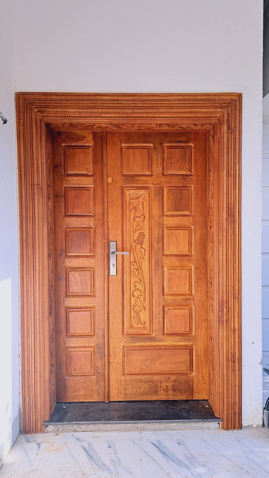 Handcrafted timber entrance door with ornamental moldings