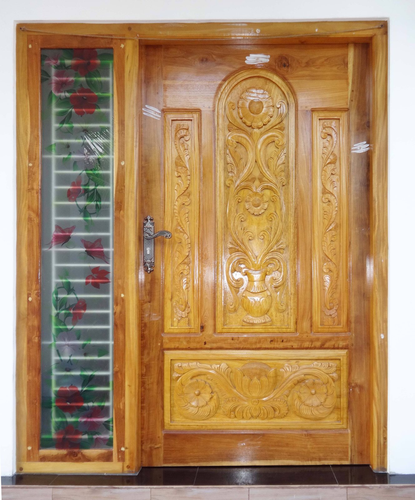 Relief-carved timber door during final workshop inspection
