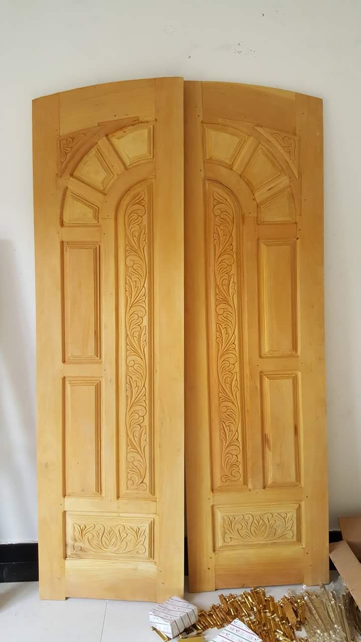Traditional carved timber pooja room door with floral medallions