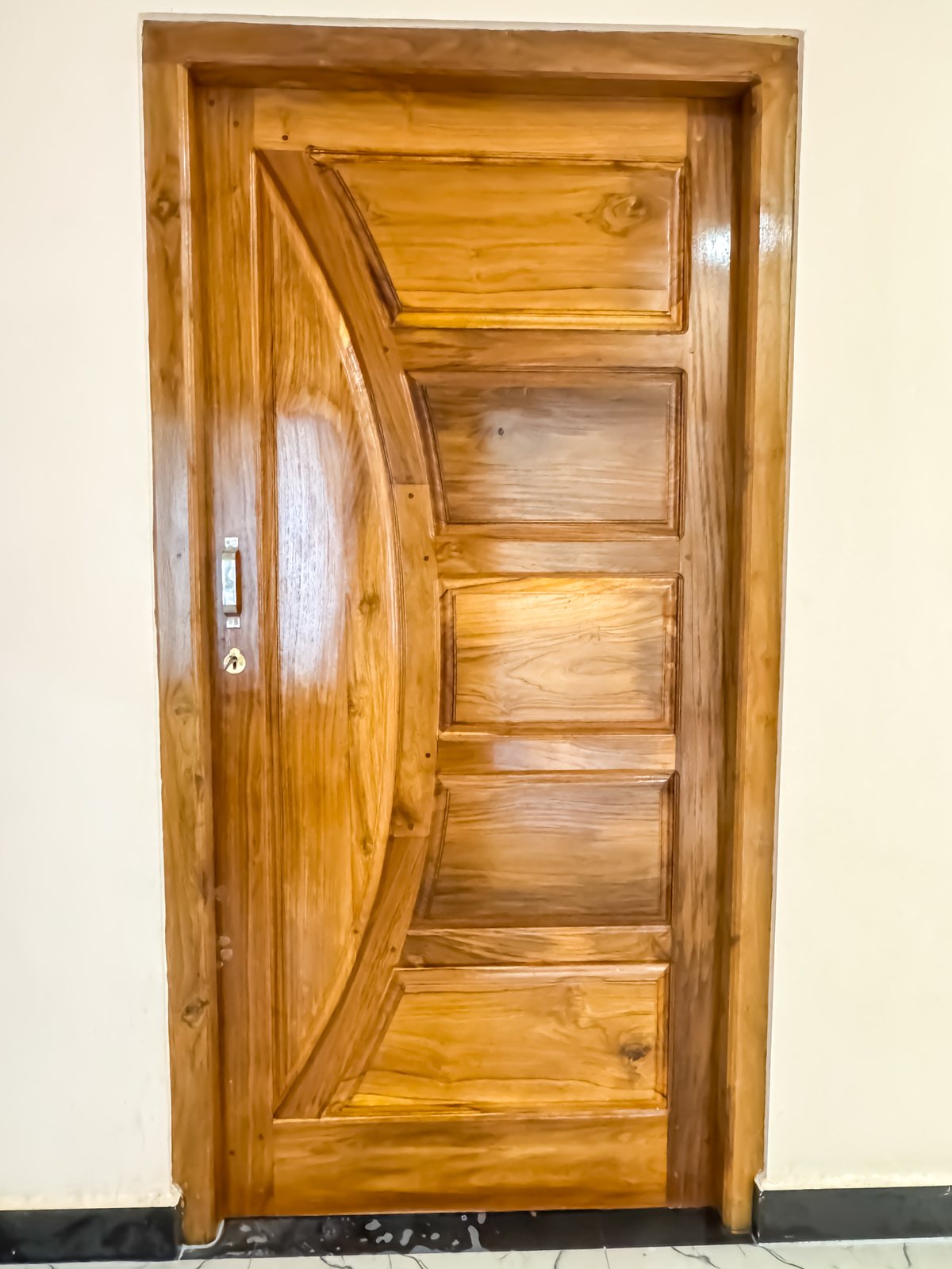 Carved hardwood main entrance door with decorative detailing