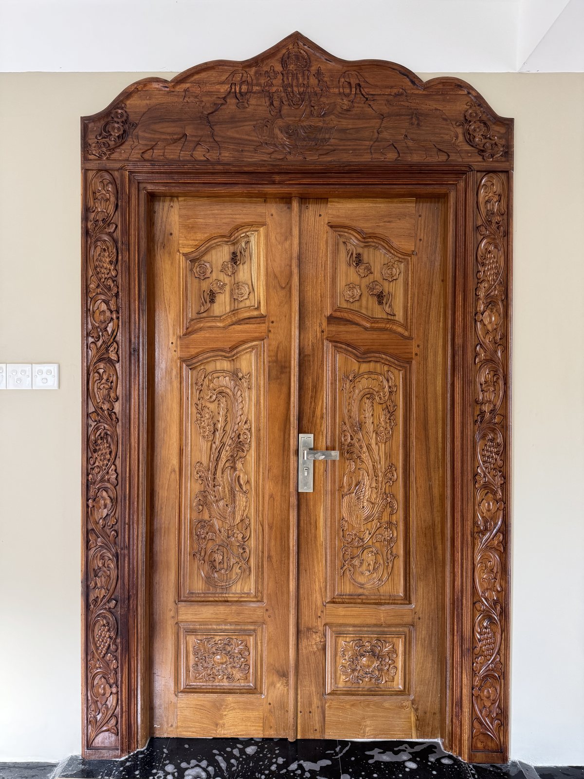 Double timber entrance door pair with symmetrical molded panels