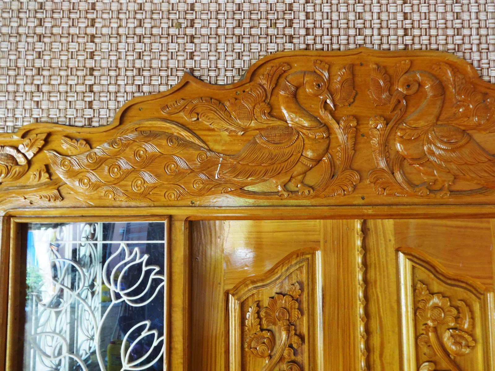 Close view of the flowing floral carving above the entrance