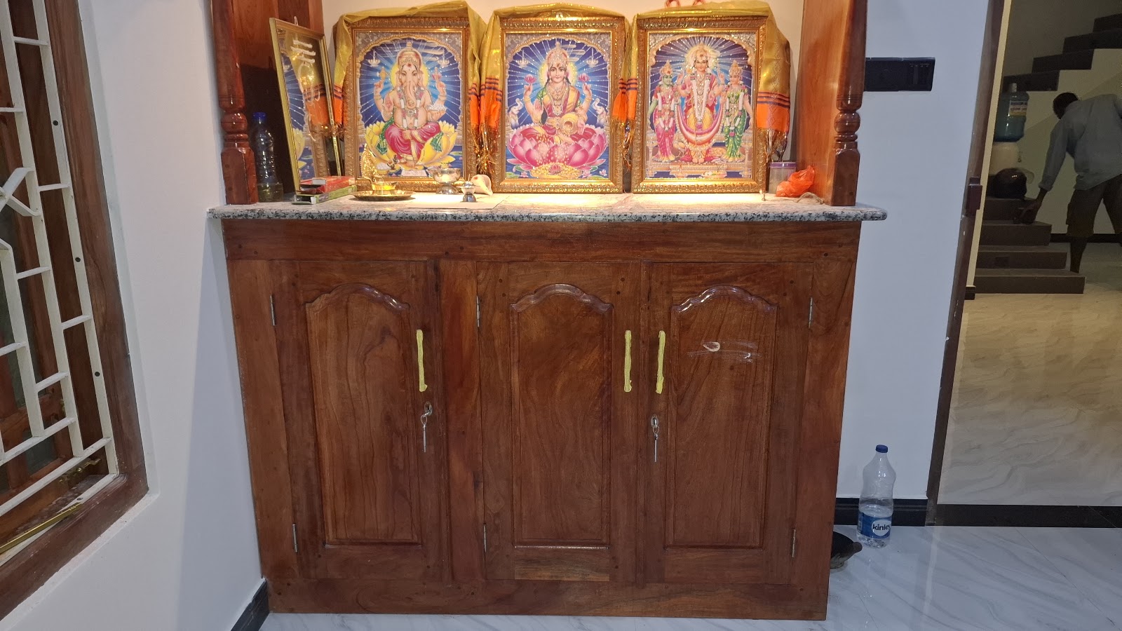 Wide front view showing the shrine display and lower cabinet storage