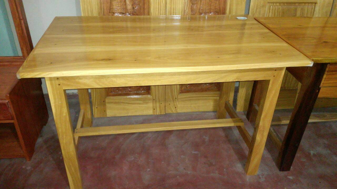 Solid wood coffee table with sculpted legs and polished timber top