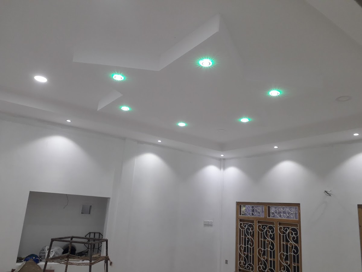 Finished emerald star geometric false ceiling with radiant emerald green ambient cove lighting and recessed ceiling spotlights