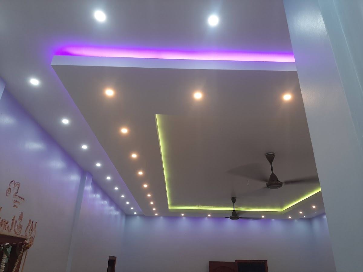 Dual-tone magenta and warm gold false ceiling tray with ambient LED strip lighting and downlights