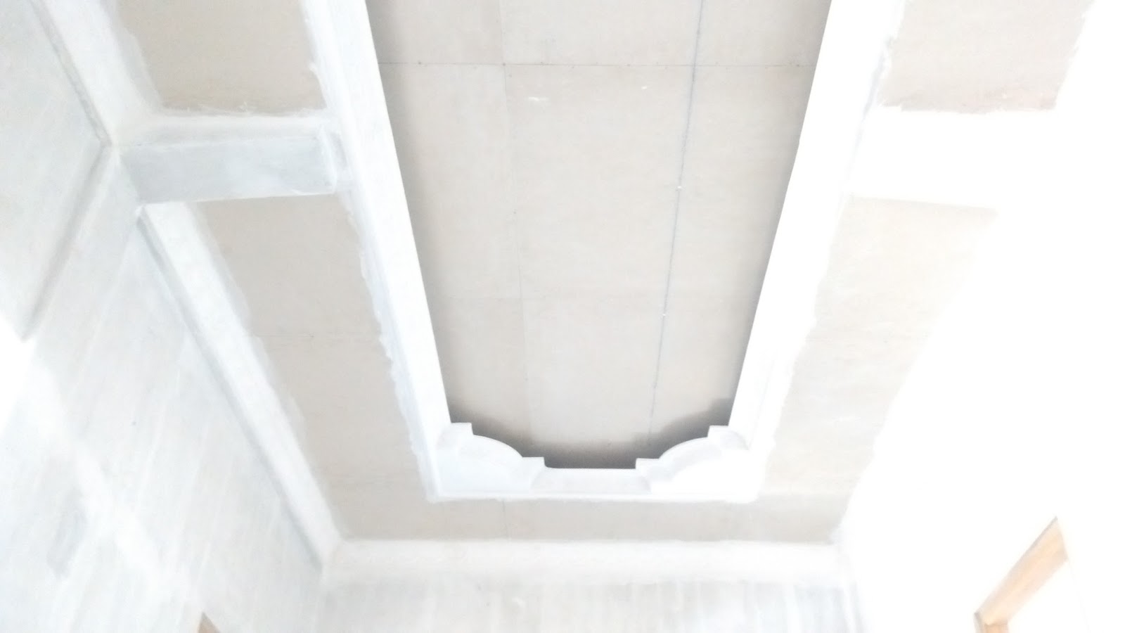 Curved scalloped edge recessed gypsum tray ceiling with hidden cove lighting