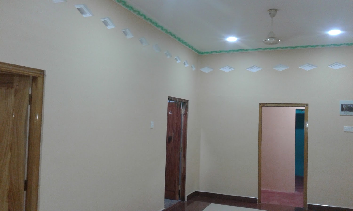 Wide view of spacious hall with finished false ceiling