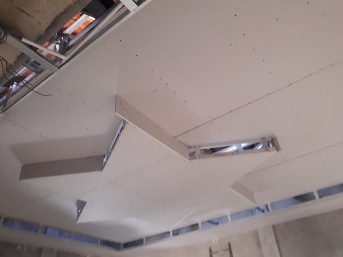 Galvanized ceiling channel framing and hanging wire grid before board fitting