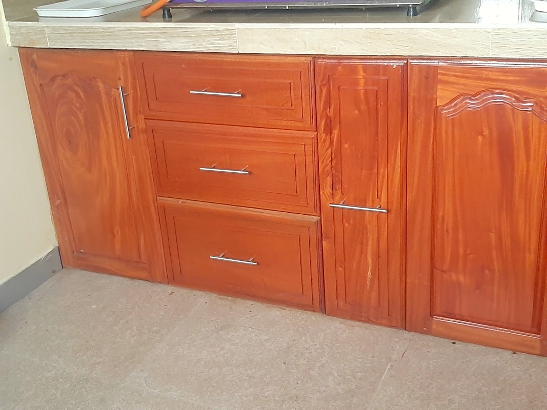 Handcrafted natural teak wall kitchen cupboards with arched glass panels