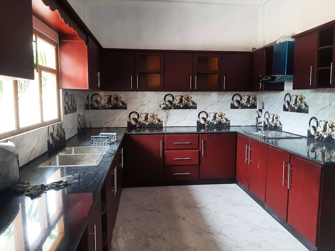 Spacious U-shaped kitchen suite with polished mahogany cabinets and integrated cooktop