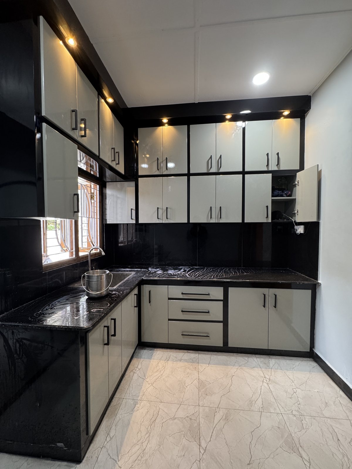 Fitted timber kitchen cabinetry suite with overhead storage