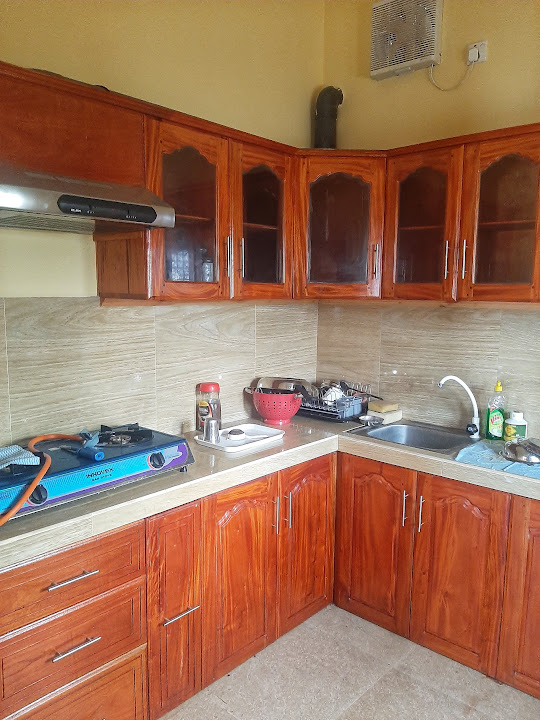 Warm-toned kitchen cabinets with glass-front upper units