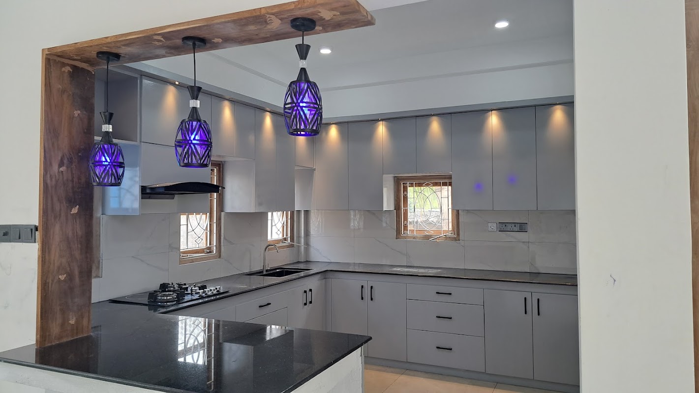 Contemporary kitchen island breakfast counter with stone top and stylish overhead pendant lighting