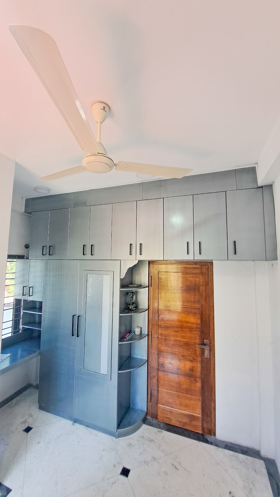 Wide view showing the kitchen cabinetry arranged around the room