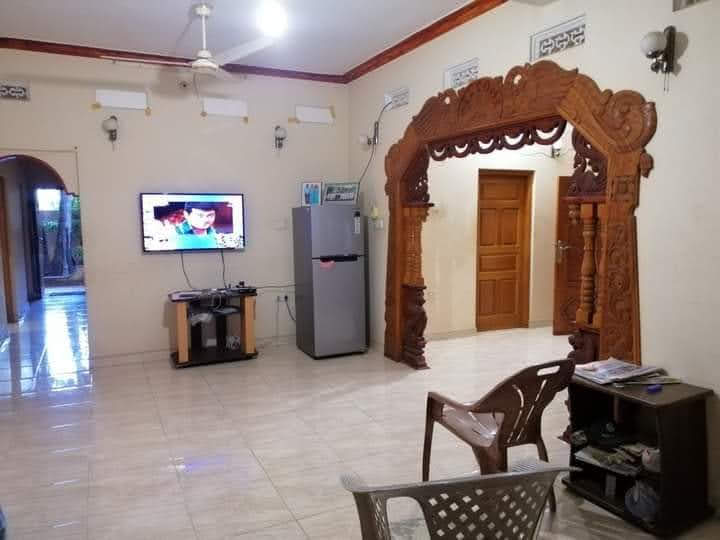 Ornate carved timber living room archway creating a feature backdrop partition