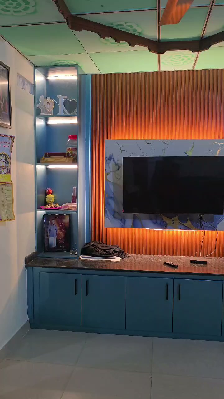 Front view of the TV wall with warm lighting behind the screen