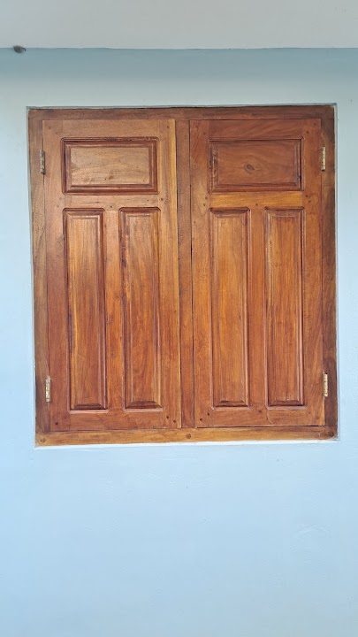 Full front view of two-panel solid timber shutter window with raised vertical panels