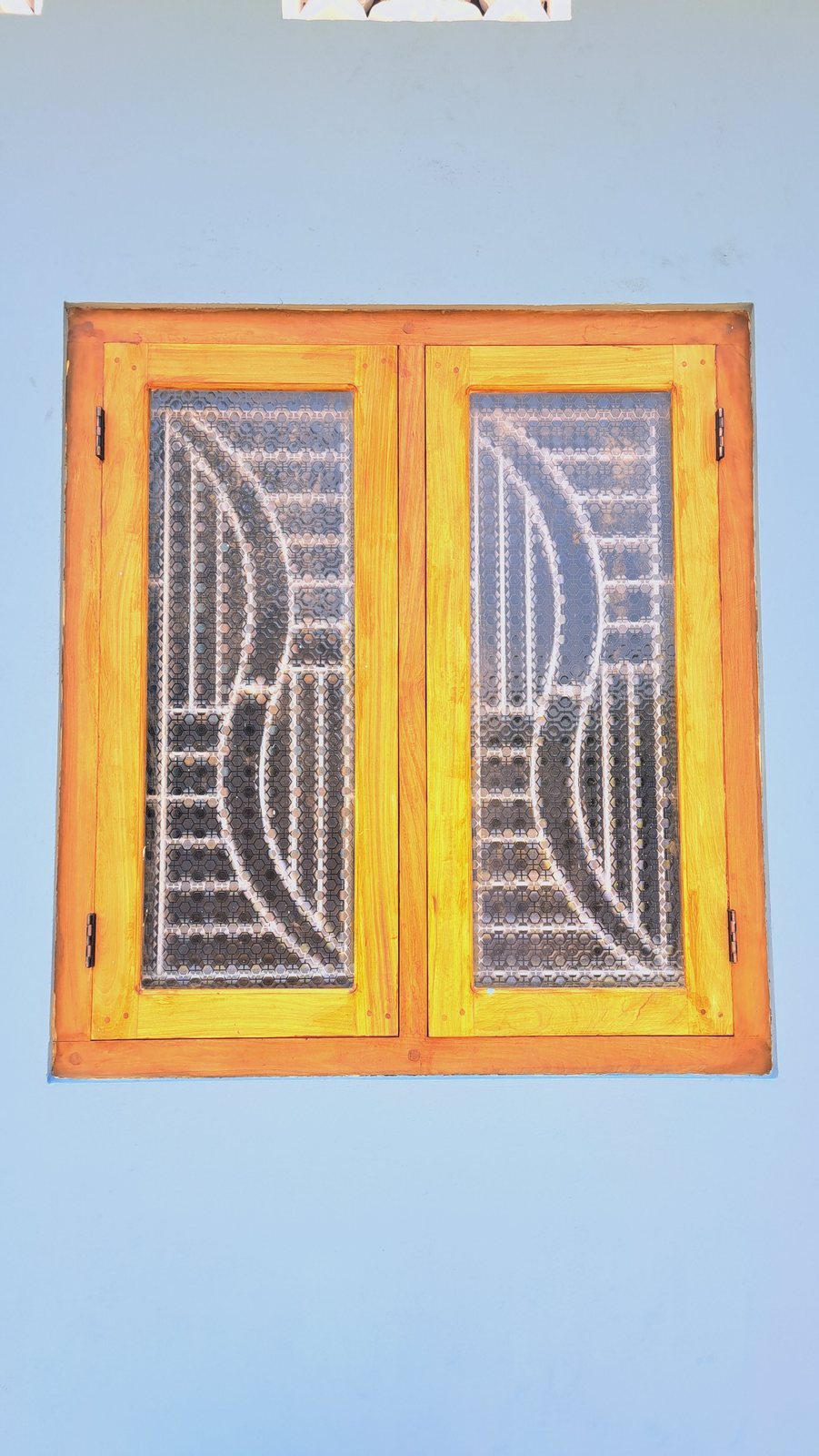 Handcrafted timber window frame with decorative curved mullions