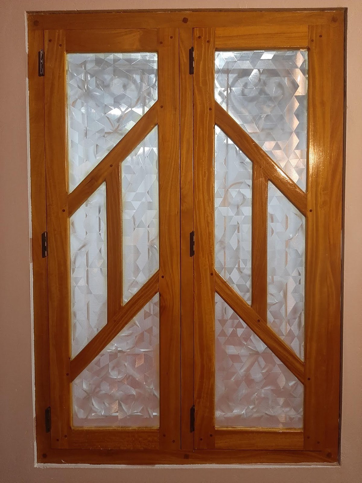 Partly open geometric timber window showing the casement leaves