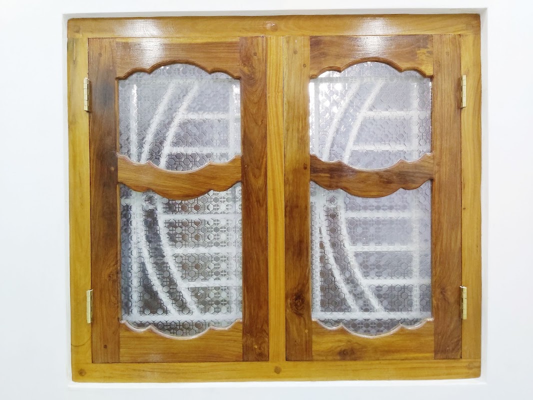 Two-sash timber window with decorative scalloped wave framing