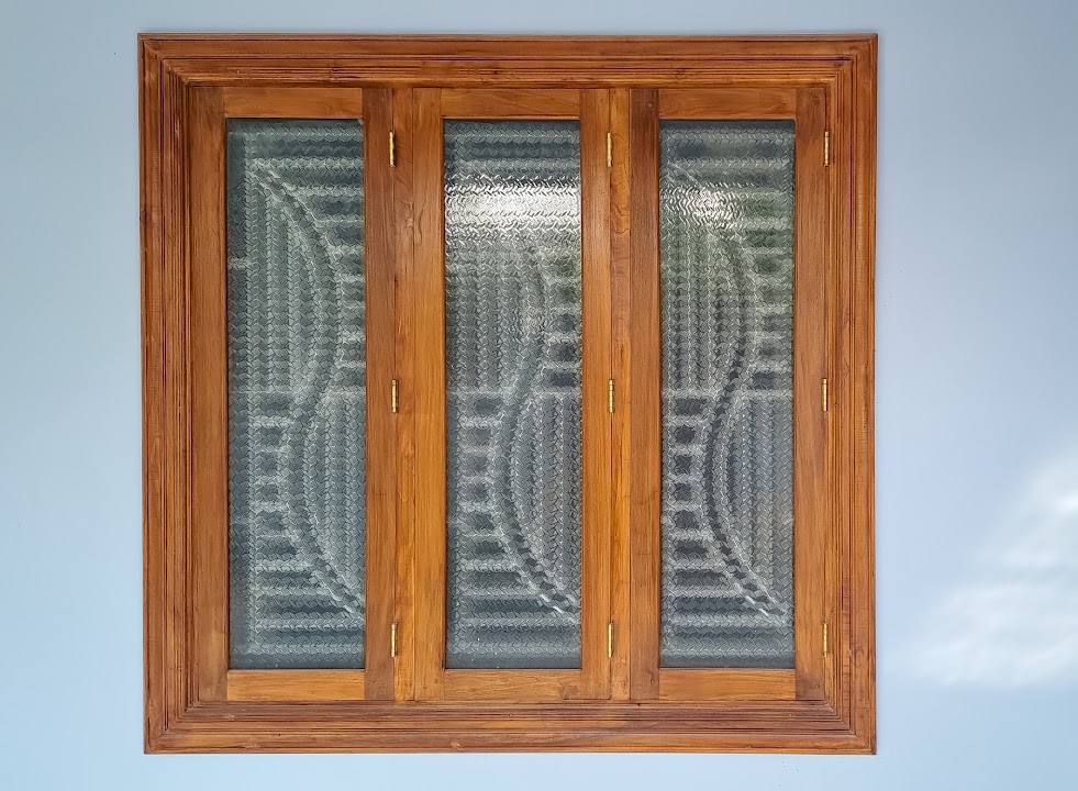 Full front elevation of three-panel timber frame window with textured glass and safety grille